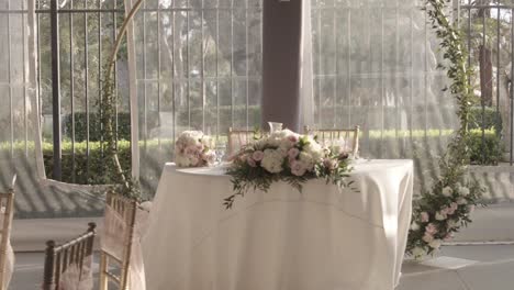 zoom dramático del arreglo floral y la decoración en la mesa de los novios