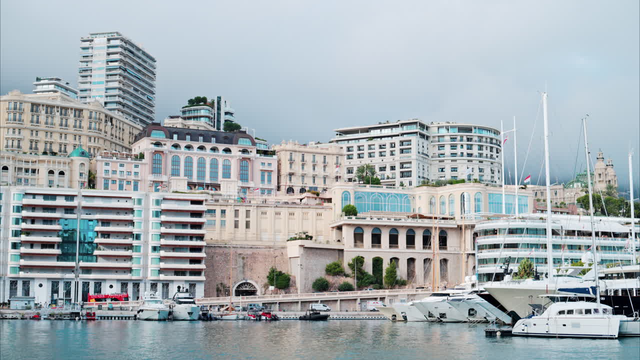 View of boats docked in the Monaco Marina with the skyline of the city on the background