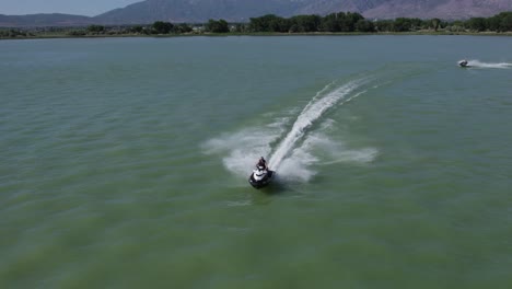 man ripping over utah lake with a jet ski, summertime recreation