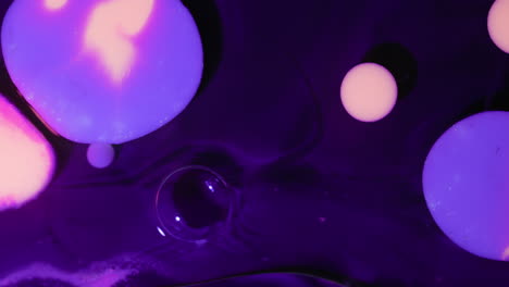 Macro-Shot-Of-Floating-Purple-Bubbles-On-Dark-Surface