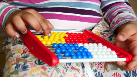 child playing with abacus