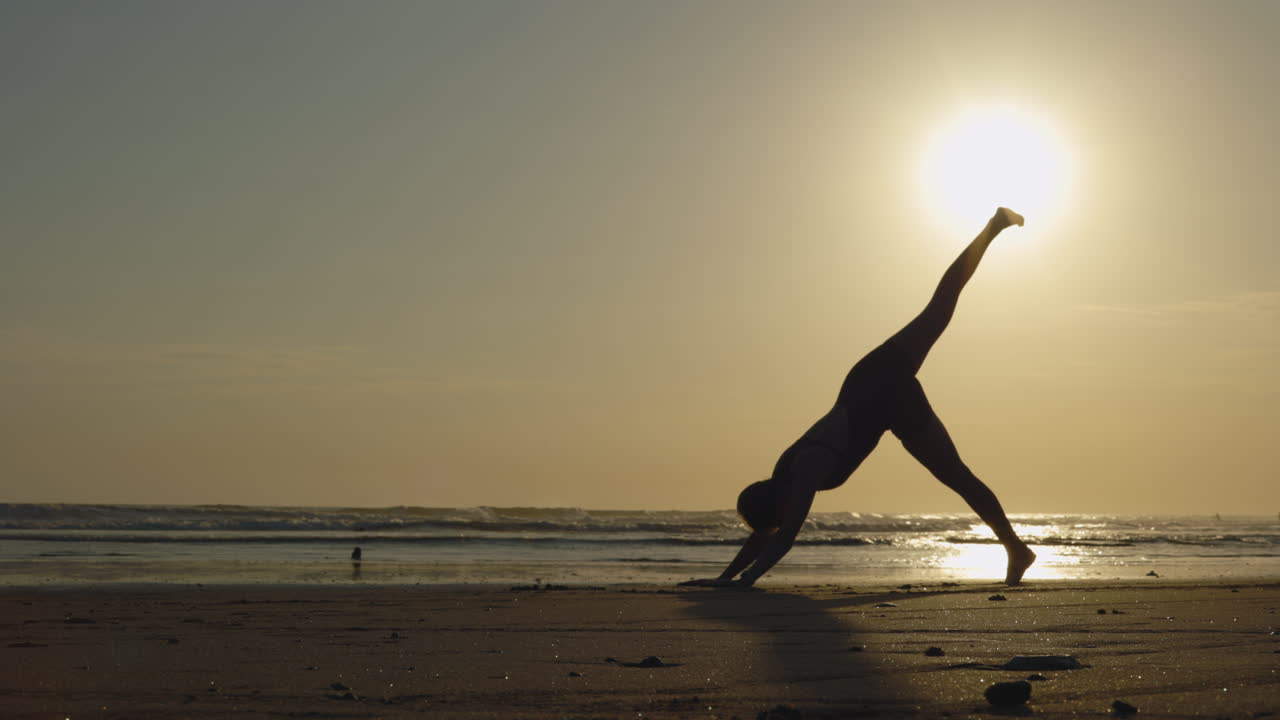 Yoga practice on the beach at sunset