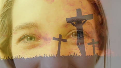 Animation-of-crosses-on-hill-over-close-up-of-person''s-eyes