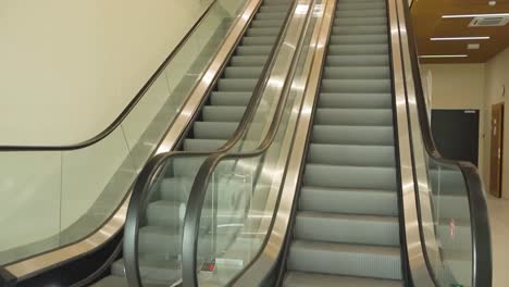 empty escalator going up in a modern building
