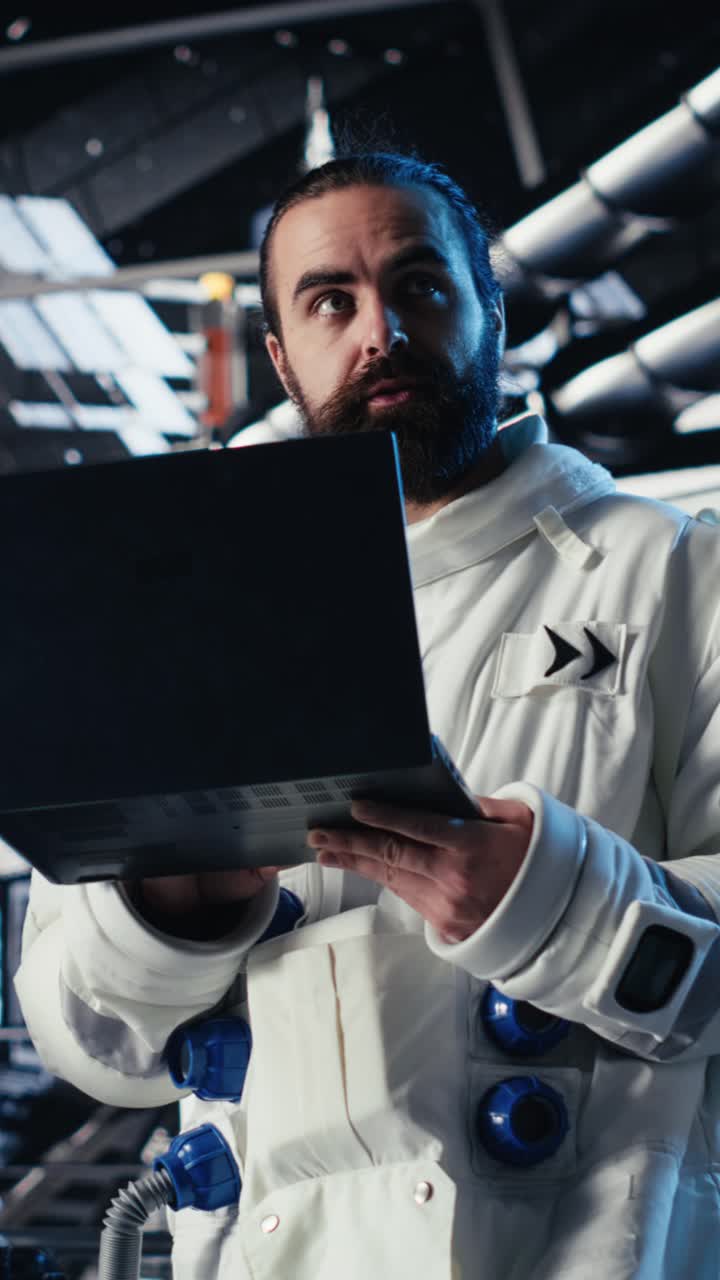 Vertical video Jolly astronaut waves hand during videocall with Earth command center