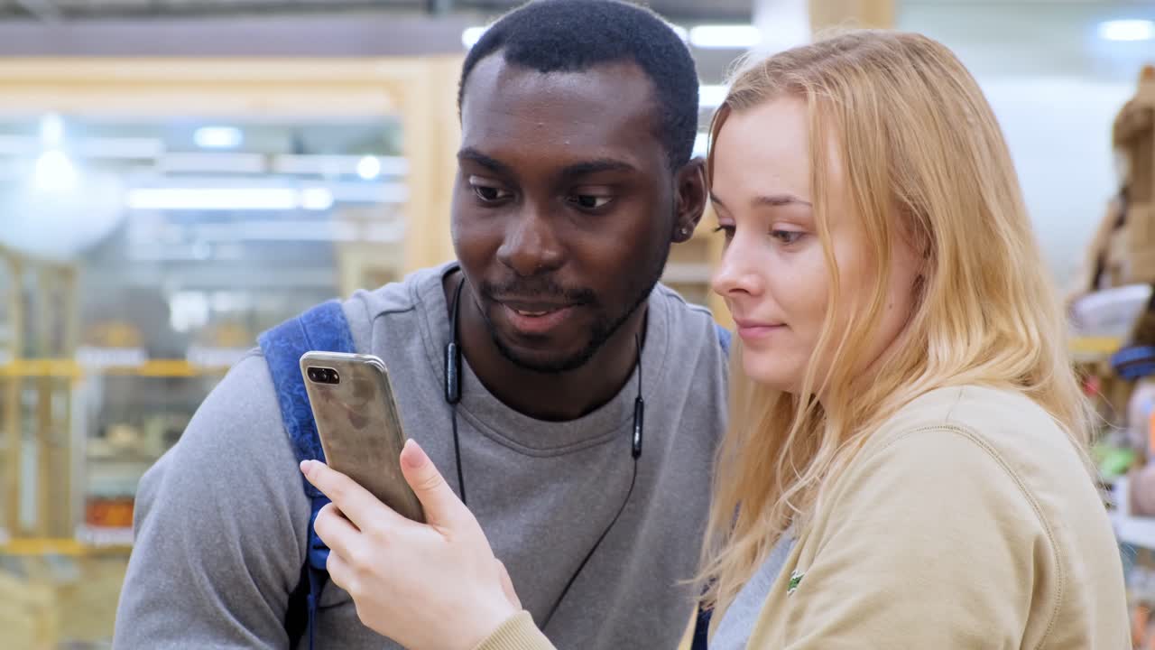 Interracial couple taking a selfie in a store
