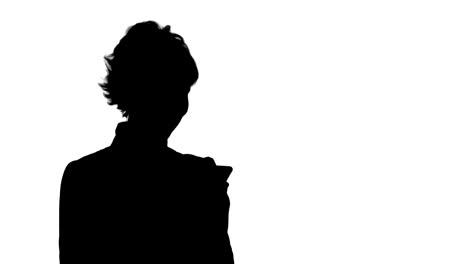 silhouette young attractive woman works on smartphone and smiles track matte