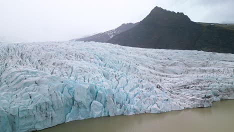 forward drone shot above melting glacier