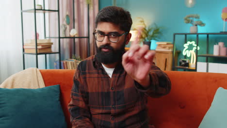 man pointing finger in living room