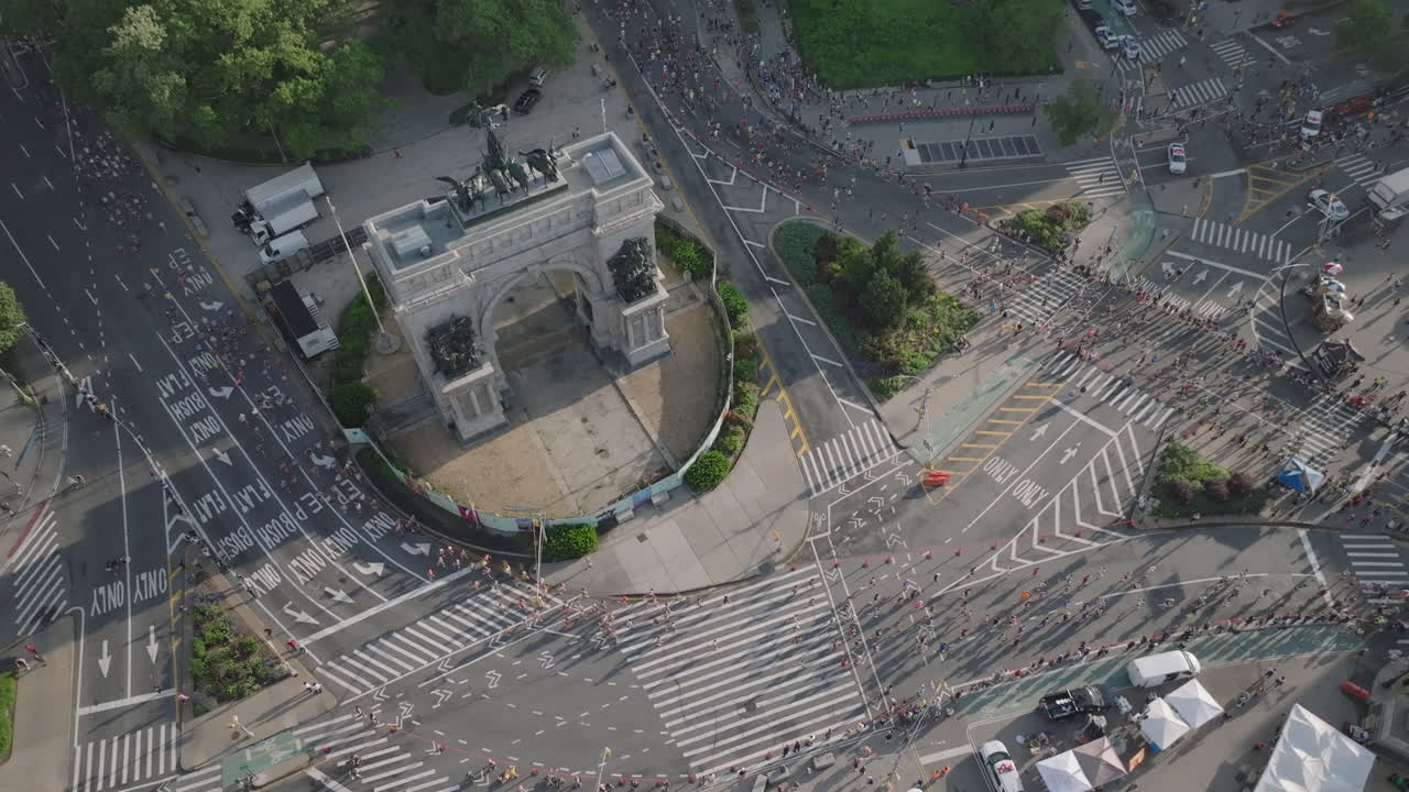 Aerial view of people running the Brooklyn Half Marathon. Shot on a summer morning at Grand Army Plaza.