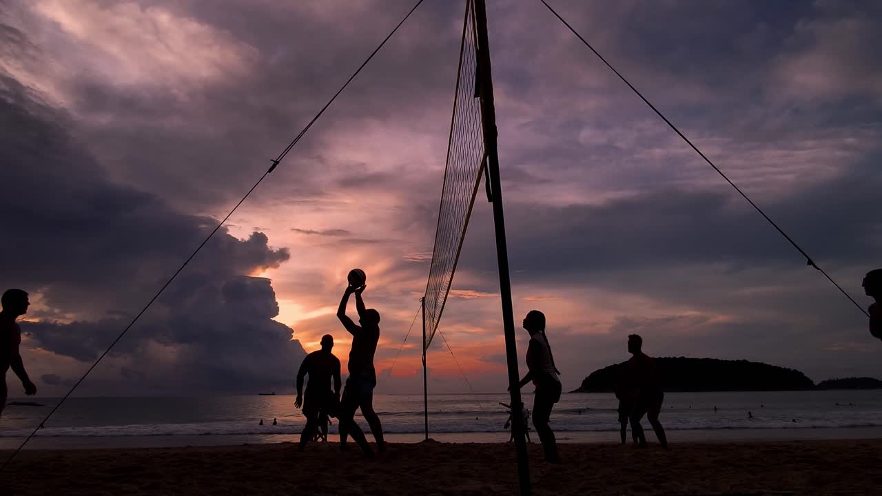 Beach volleyball at sunset