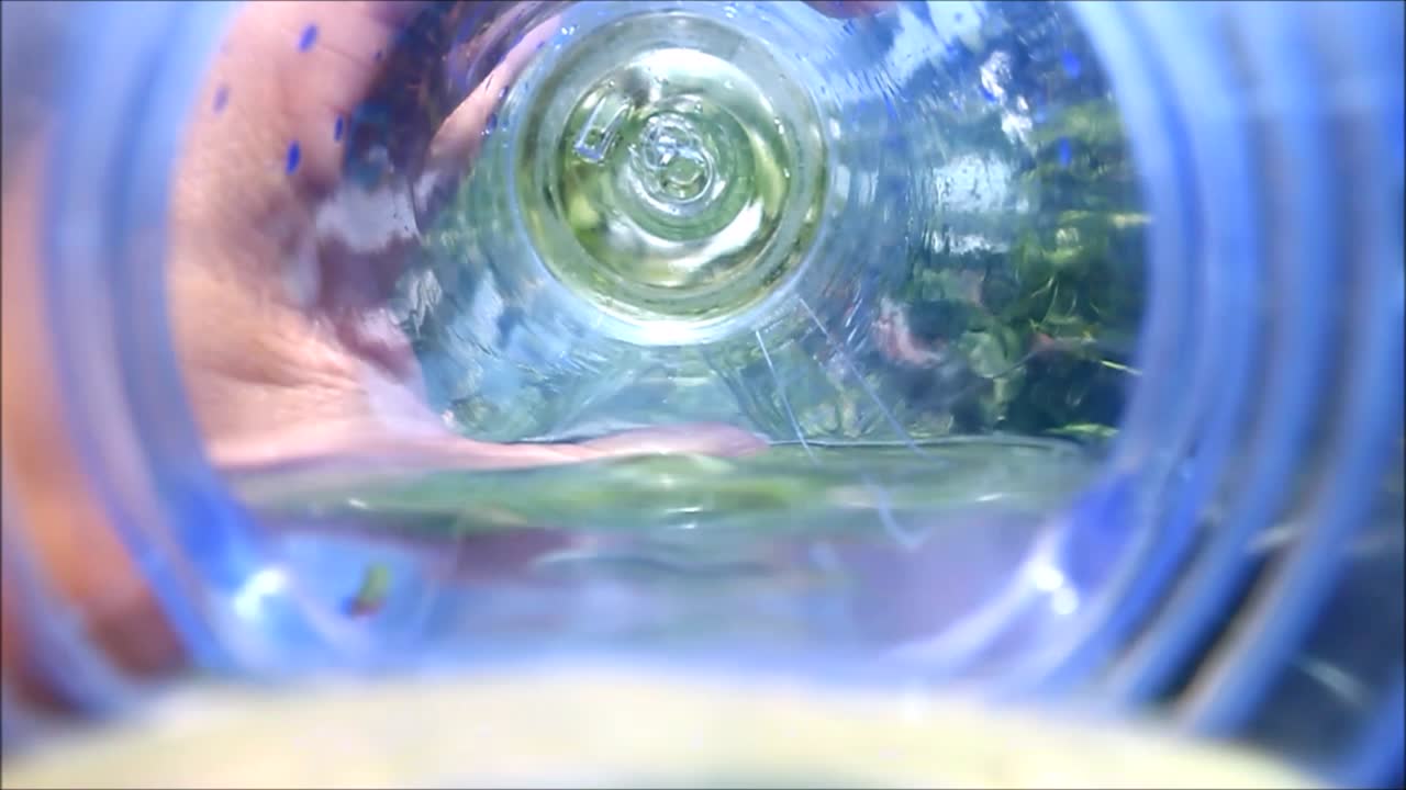 Slow motion first person view video shot of a person drinking water from a water bottle