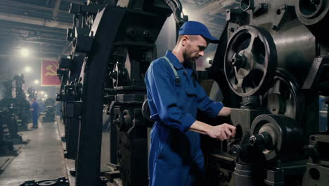 industrial worker operating vintage machinery in a soviet-era factory