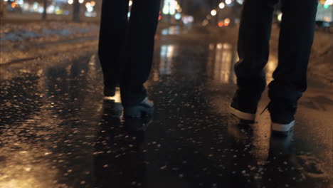 view to the feet walking in evening city