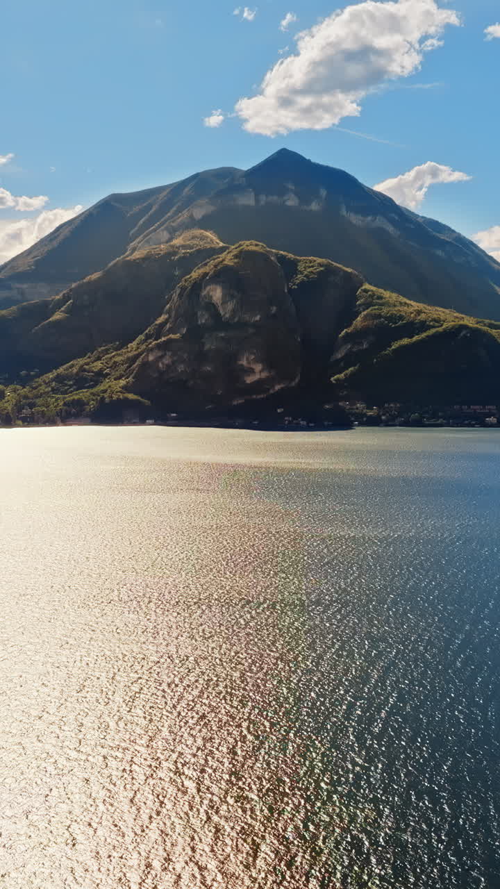 Aerial drone view of the Alps with a blue sky near Lake Como, Italy. Vertical
