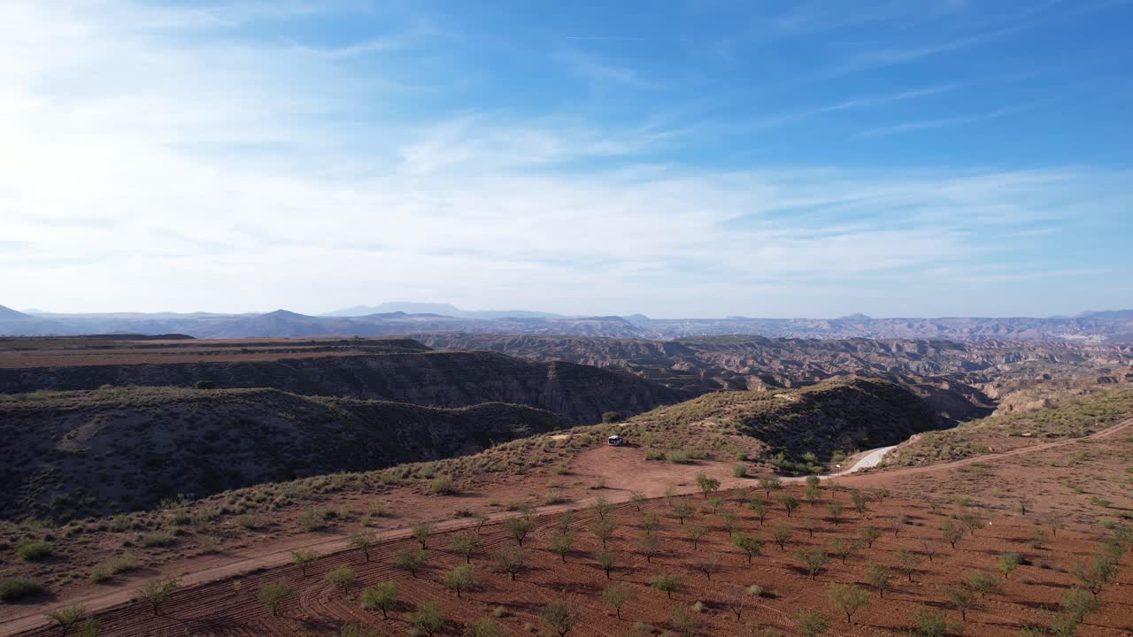 Van parked on the edge of a hill with a rural road. Gorafe desert in Granada, Spain