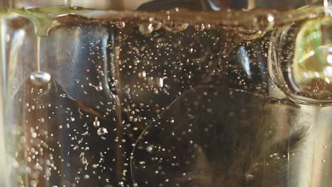 pouring soda or water with ice into a glass