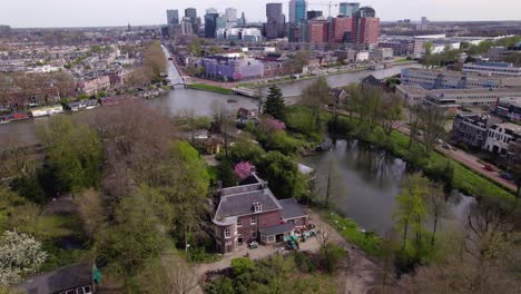 Aerial-view-of-Oog-in-Al-park-with-early-morning-sunrise-cityscape-of-Utrecht-in-the-background