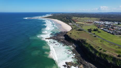 foamy waves crashing on the rocky coastline of whites head near sharpes beach in nsw, australia