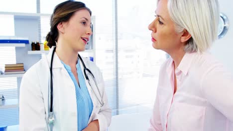 Female-doctor-discussing-over-medical-report-with-patient