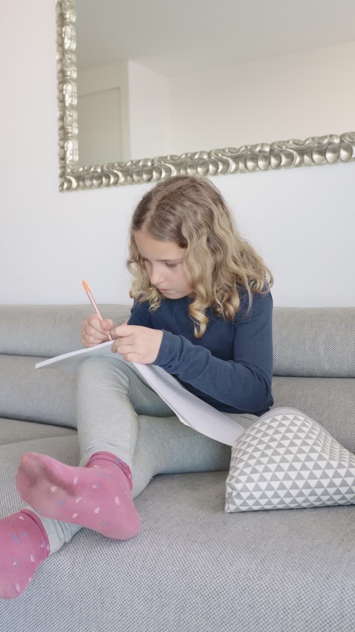 Girl drawing on sofa