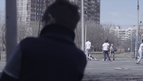 children playing basketball in an urban playground