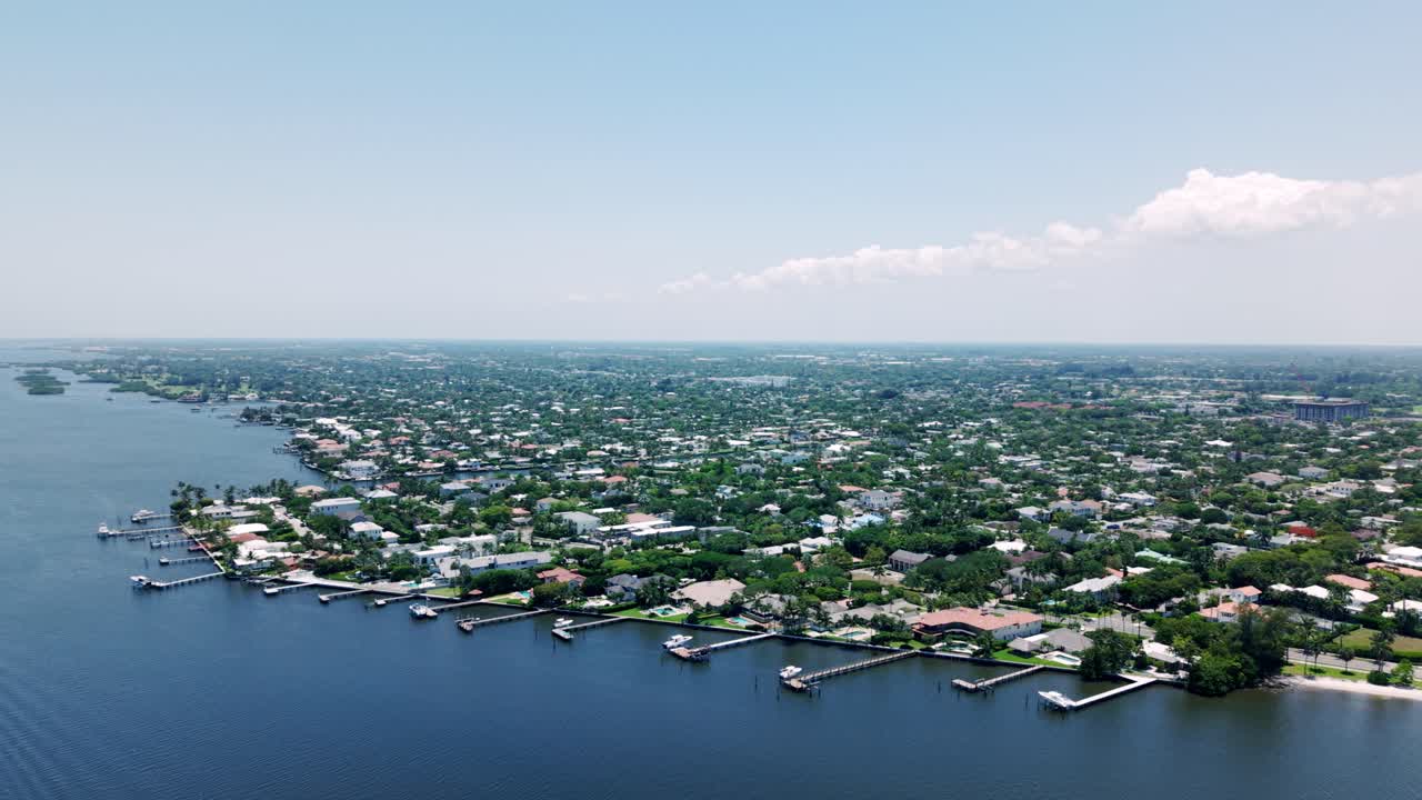 High angle drone of beach, trees, and buildings in West Palm Beachs Flagler area