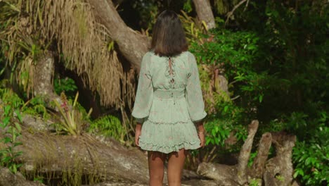 a young girl with ringlets explores a tropical park on the beautiful island of trinidad