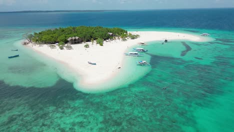 Patawan-Island-aerial-panoramic-overview-of-bungalow,-banca-boat,-and-tourists