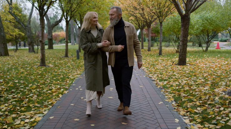Happy senior couple walking through the park