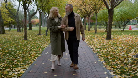 Happy-senior-couple-walking-through-the-park