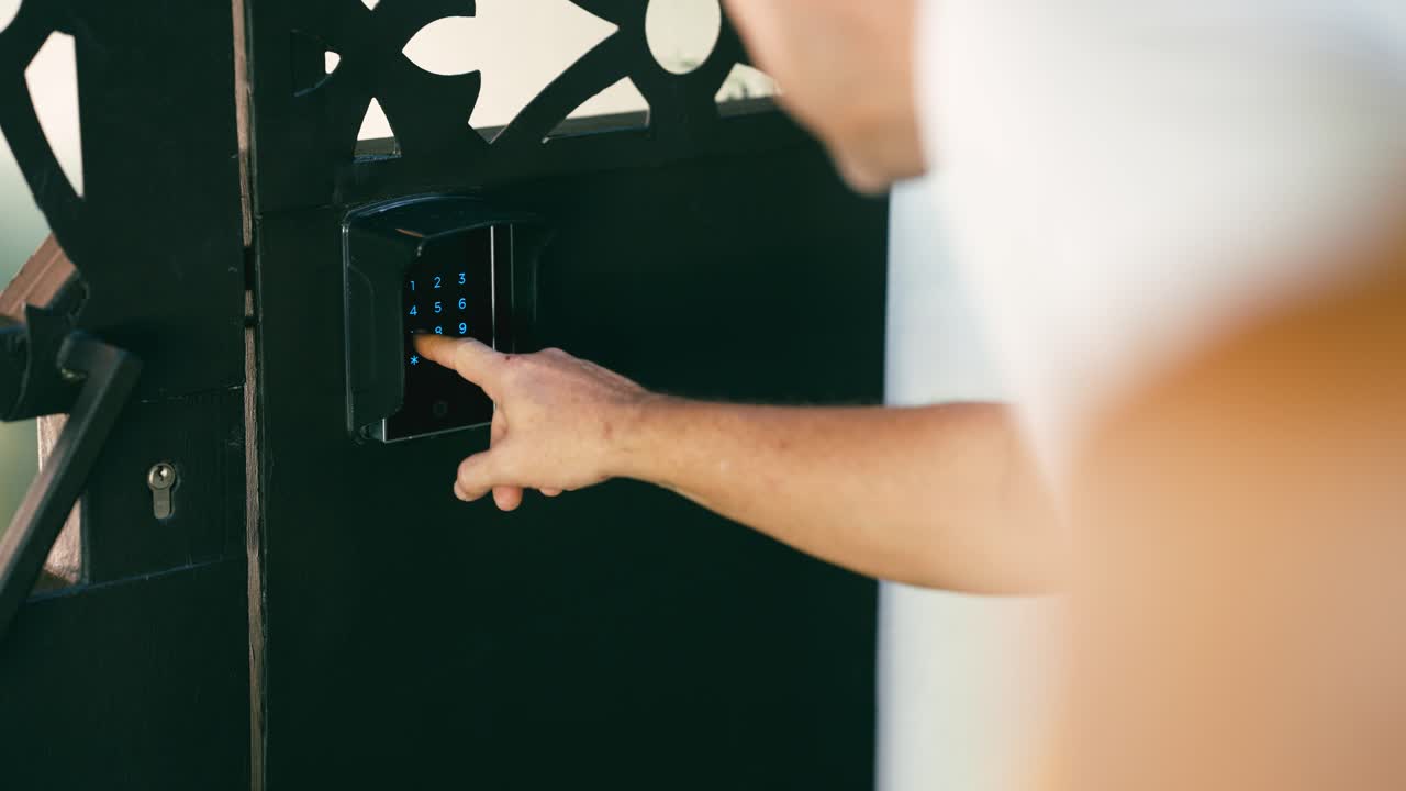 Close-up of Hand Entering Code on Digital Keypad to Open Gate