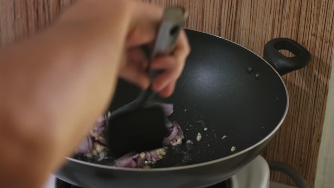 Sauteing Garlic and Onion In Pan With Oil. - closeup shot