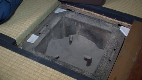 ashes are added to prepare a japanese shichirin charcoal stove before use