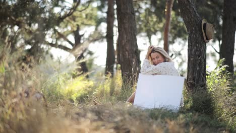 a young artist is sitting in a field of tall grass painting a beautiful picture she is feeling