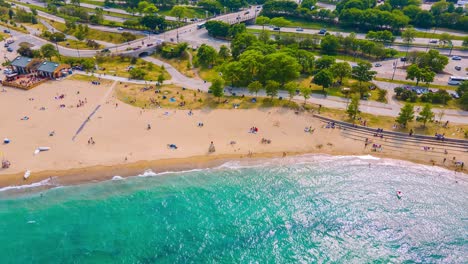 hyper-lapse-aerial-drone-footage-of-the-Chicago-beach-during-mid-summer-on-a-bright-sunny-day