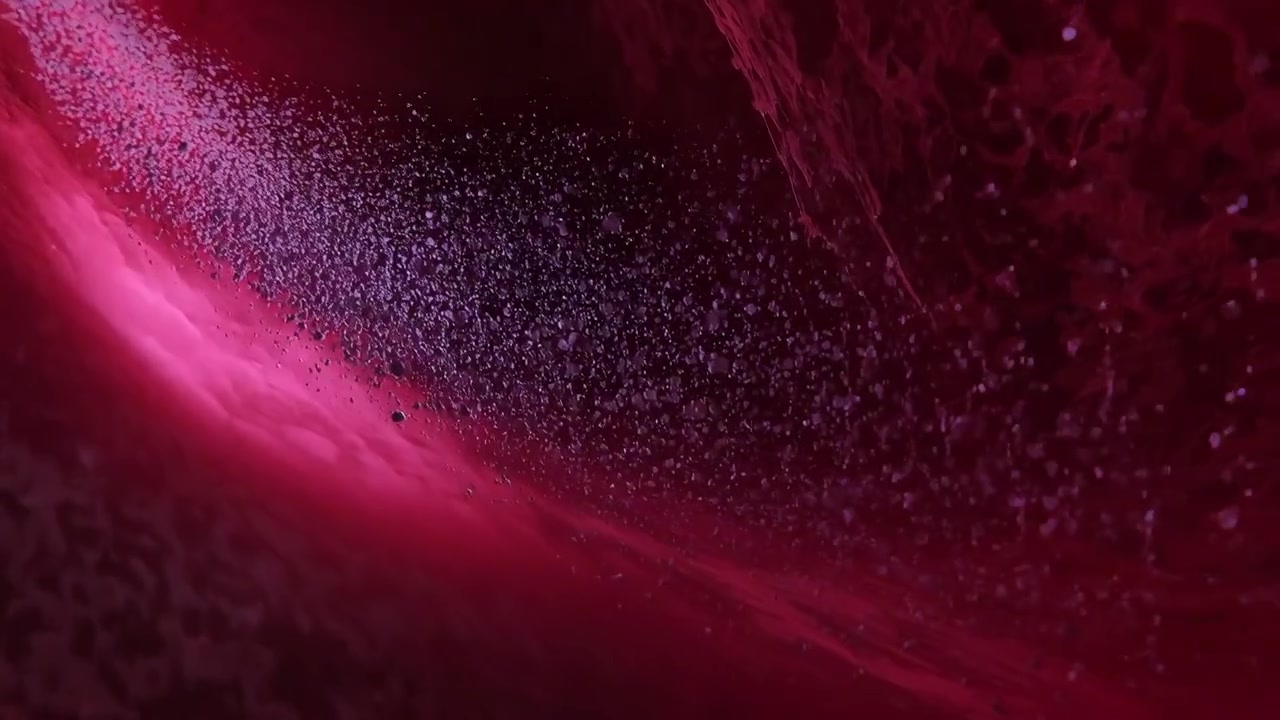 Revealing curved magenta surface at macro scale shifting light, densifying particles along crescent