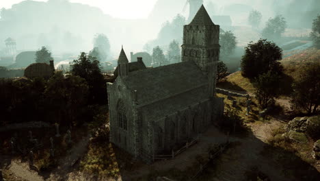 a stone church stands tall in a medieval village