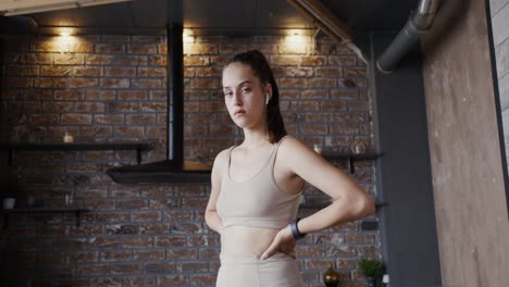 young woman in fitness attire standing in a kitchen