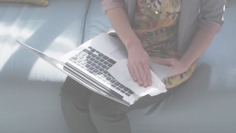 Animation-of-flashing-words-with-woman-disinfecting-her-laptop