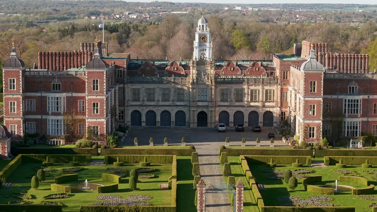 Aerial view establishing majestic Hatfield house Elizabethan manor gardens secluded in Hertfordshire