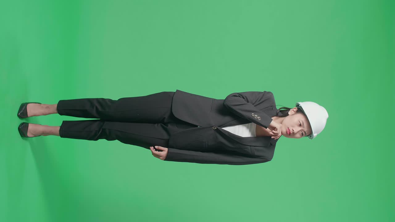 Full Body Of Asian Female Engineer Thinking About Something And Looking Around Then Raising Her Index Finger In The Green Screen Studio