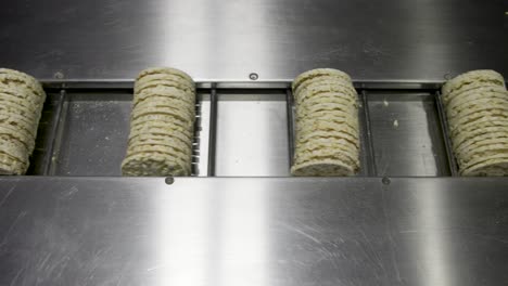 Shot-of-a-moving-conveyor-with-einkorn-cakes