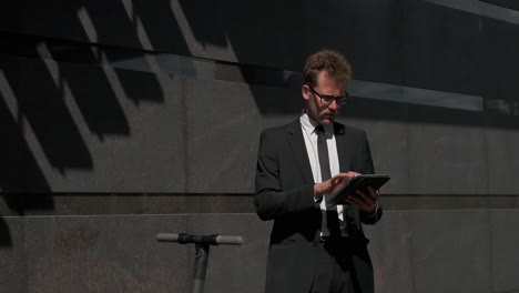 businessman using tablet outside