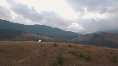 Lovely-newlyweds-bride-groom-dancing-on-mountain-autumn-slope,-aerial-view,-wedding-couple-family