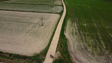 Ein-Paar-Freunde-Gehen-Auf-Einem-Verengten-Weg-Abseits-Der-Straße-In-Der-Luftaufnahme-Der-Landschaft