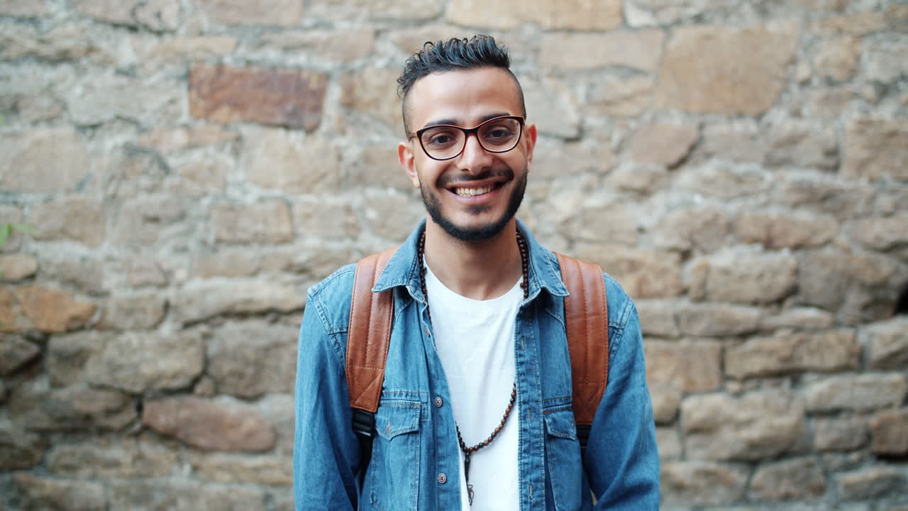 Smiling Young Man with Glasses and Backpack