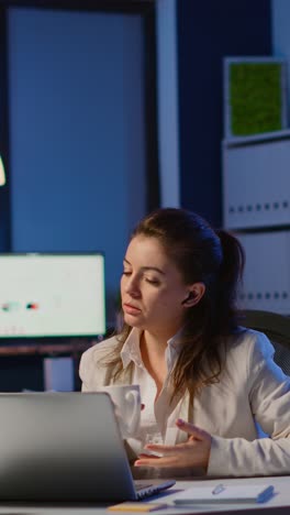 vertical video: manager speaking online with remotely coworkers late at night