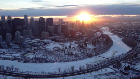 a drone's aerial view of calgary's downtown during a winter sunset