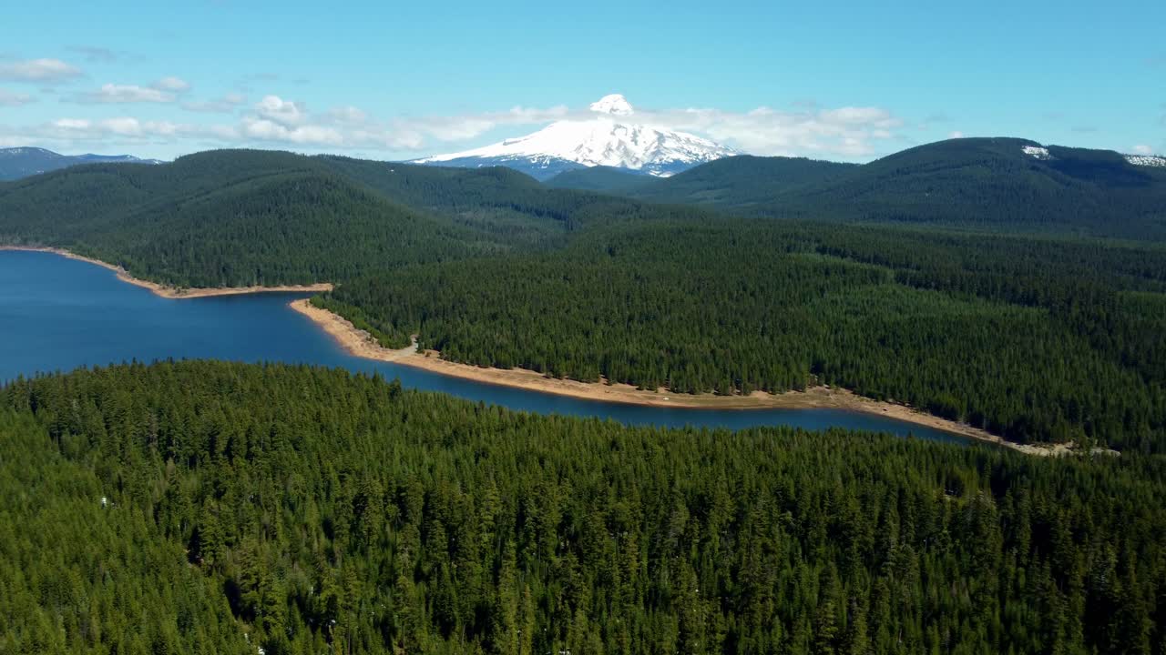 US, Oregon, Mt Hood, Clear Lake, 2025-04-22 - Drone view of Mt Hood at Clear Lake. On a spring day, with some clouds, viewed from the Southeast.